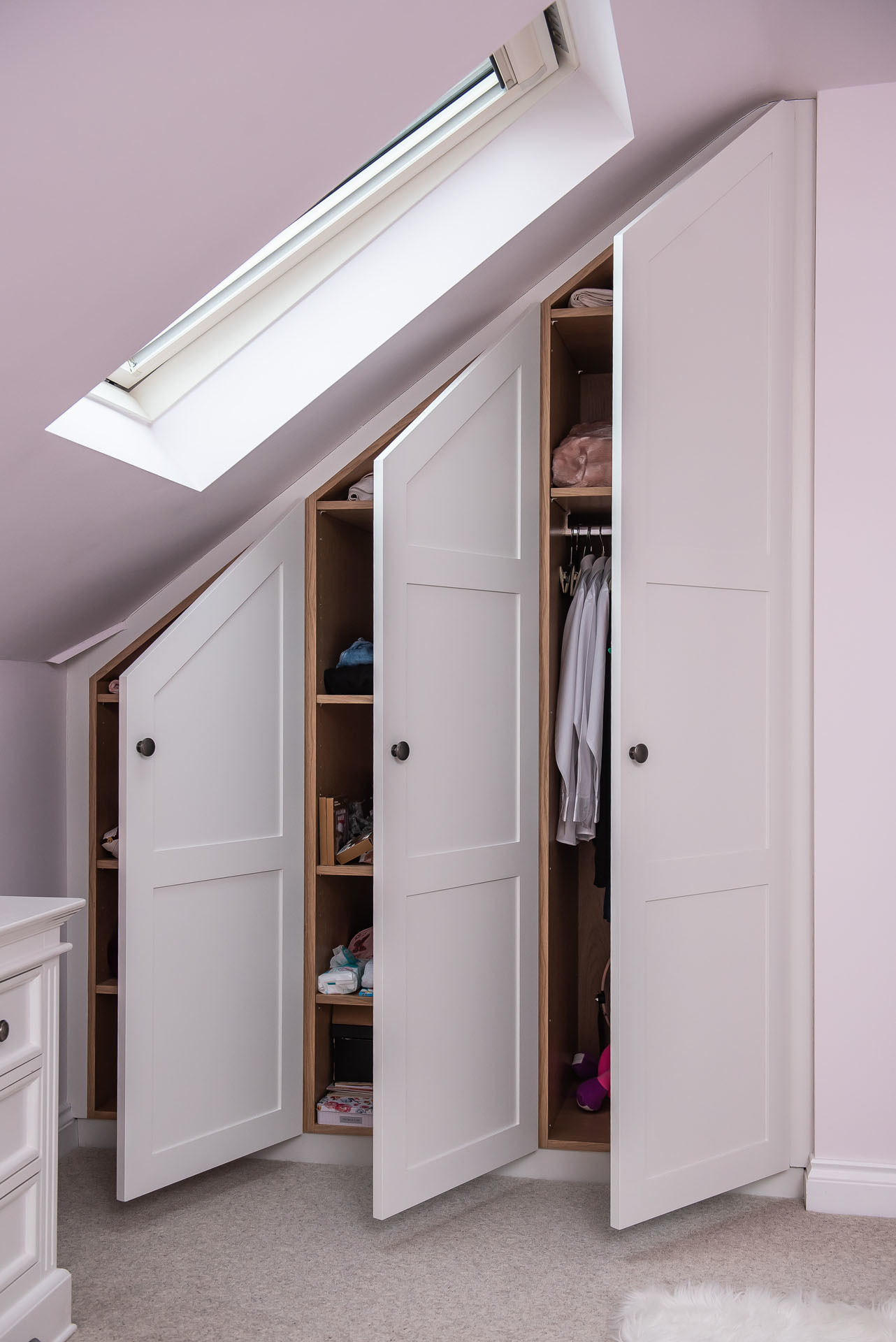 white angled bedroom wardrobes in loft room with oak veneer internals and open shaker doors in Redbourn